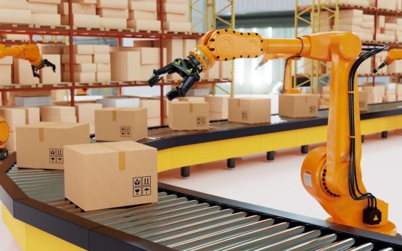 Industrial robot arm grabbing the cardboard box on roller conveyor rack with storage warehouse background.
