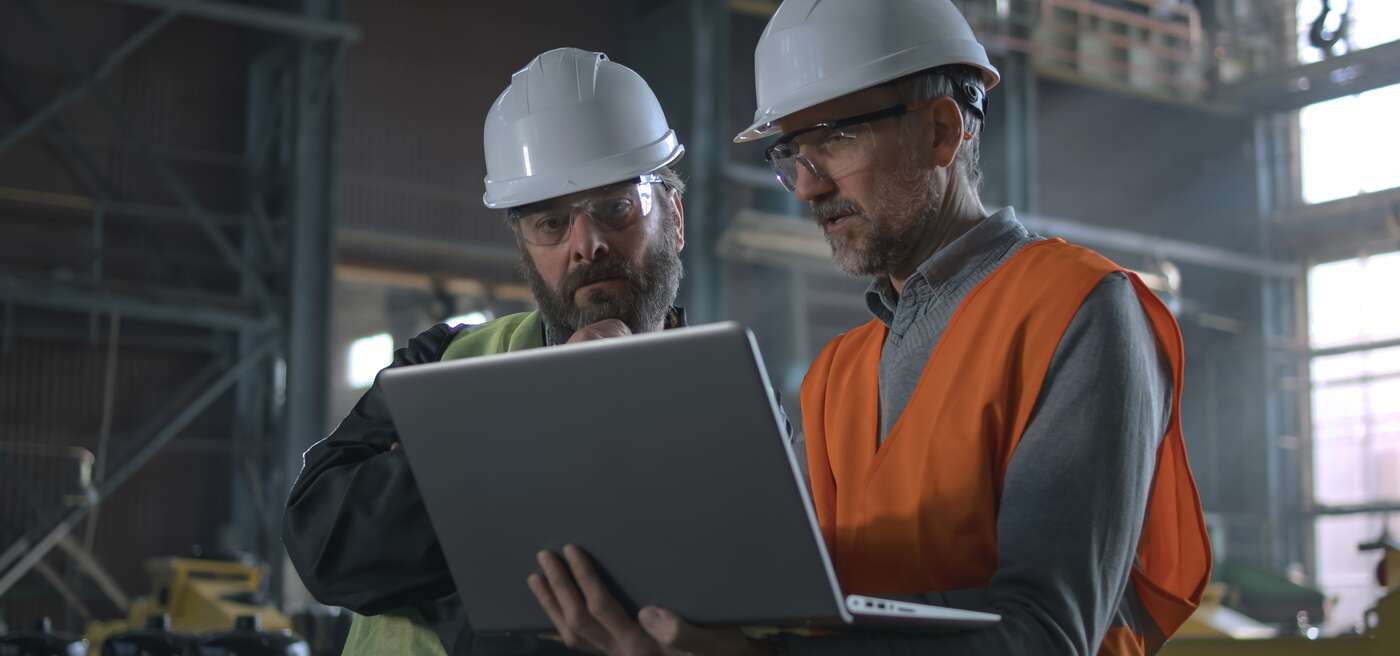 Two Professional Heavy Industry Workers on Manufacturing Floor